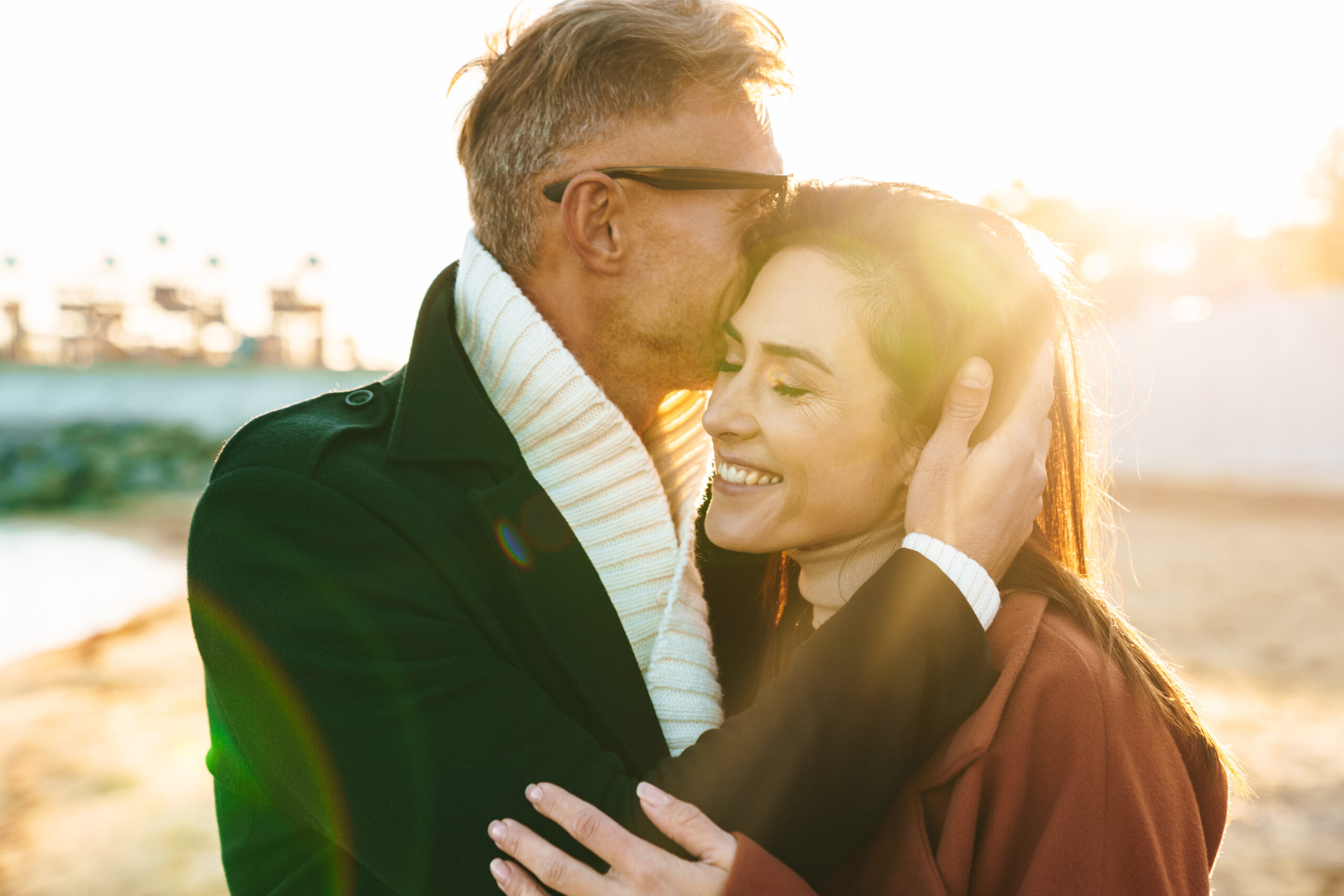 man kissing wife on her forehead