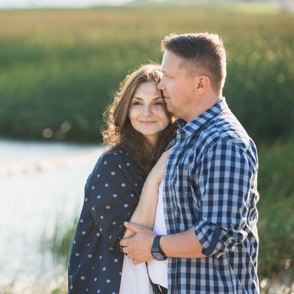 middle age couple holding each other looking at a lake